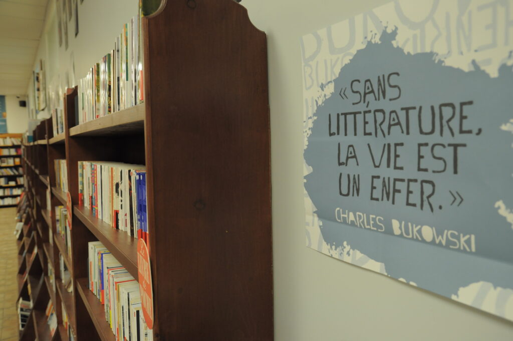 View of wall art and bookshelves from Les Bouquinistes